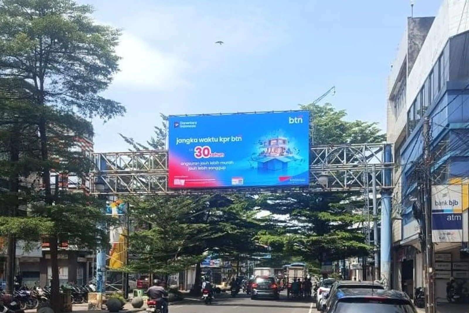 LED bando P6.67 melintang di atas Jalan Jenderal Sudirman Bandung menayangkan iklan KPR bank pada siang hari